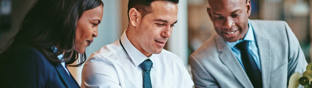 Woman and two men in business attire.