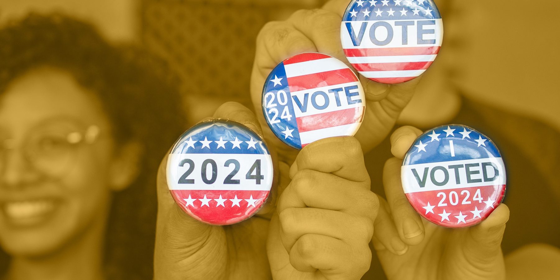 Hands holding "Vote" and "Voted" button pins.